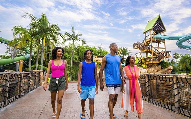 Guests walking across a bridge at Aquatica Orlando